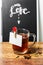 Glass tea Cup on a background of chalk boards, with spices and empty note