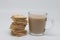 Glass of tea with milk and a stack of biscuits, proper nutrition