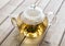 A glass tea pot with Flower Chinese tea on wooden background