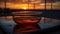 a glass of tea sitting on top of a table next to the sun setting in the sky behind a fenced in area with trees