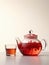 Glass teapot and cup of rooibos tea.