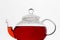 Glass teapot with hibiscus karkade tea at white background