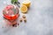 Glass teapot with tea, mint and lemon on grey table with copy space