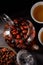 Glass teapot with vitamin drink from essential rosehips. Rosehip tea. Vitamin drink on a dark background. Top view