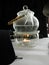 A glass teapot with water stands above the flame of a candle on a stand