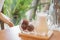 Glass of three iced coffee balls on wood tray served with milk,  homemade latte refreshment in cafe background