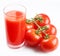 Glass of tomato juice and ripe tomatoes