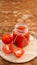 Glass of tomato juice on wooden table. Fresh tomato juice and chopped tomatoes