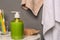 Glass with toothbrushes and bottle of liquid soap on table