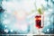 Glass of traditional mulled wine or punch on table at frosty winter day background with snow