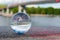 Glass transparent ball on bridge background and