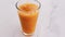 Glass of tropical orange juice with chia seeds on marble table, drink and beverage