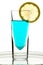 Glass with turquoise drink and lemon