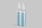 Glass Vaccine Bottles With Light Blue Liquid Content on Light Background. Medicine or Beauty Products.