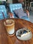 A glass of Vanilla Latte and blueberry cheese cake