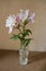 Glass vase with pair of pink and white double lilies