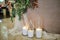 Glass vases with white burning  candles stand on the floor