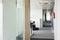 Glass wall and narrow passageway in office