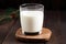 glass of warm milk on wooden table