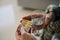 Glass of water and antidepressant medication in hands of soldier