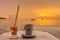 Glass of water on the beach table at Vongdeuan beach sunset in t