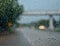 Glass water droplets. Blurred background. Road with cars. Concept. Rainy season driving on bad weather days. poor visibility feels