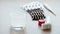 Glass of water with effervescent tablet and various pills