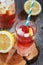 Glass of water with raspberries, slices of lemon and ice