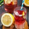 Glass of water with raspberries, slices of lemon and ice