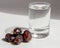 A glass of water with some medjool dates on it, dates and water picture