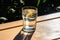 A glass of water in the sun with caustic light effects created with generative AI technology