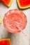 Glass of watermelon smoothie with drink straw, top view