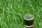 Glass of wheatgrass juice on a wheat field.