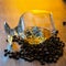 A glass of whiskey with ice and coffee beans on a wooden table. Strong alcohol with ice. Vintage close-up of golden cognac.