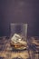 Glass of whiskey with ice on a wooden table. Selective focus. Transparent glass with alcohol with ice