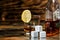 Glass of whiskey with lemon and chilling stones on a glass table next to the bottle