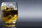 A glass of whiskey liquor with ice studio commercial promotion and marketing product background