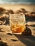 Glass of whiskey sitting on the sand