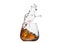 A glass of whiskey with splashes from the ice cube isolated on white. alcohol splashes. whisky or cognac or another type of