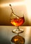 Glass of whiskey with a wave on an orange background