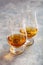 Glass of whisky spirit brandy on gray concrete background