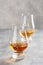 Glass of whisky spirit brandy on gray concrete background