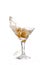 glass on a white background; the water ripples and splashed as a green spanish olive with pimento is dropped into the gl