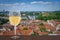 Glass of white wine against Vilnius city center. Vacation concept. View from above of St. Stanislaus Cathedral on Cathedral Square