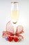 Glass of white wine with balls, candy cane and rib