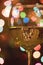 Glass of White Wine with Colorful Christmas Light Bokeh.
