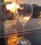 Glass of white wine by fireside with sunset in the background