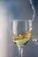 A glass of white wine. Frozen liquid flow above the edges of the glass