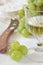 Glass of white wine, green grapes and soft French cheese Coulommiers