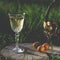 A glass of white wine on nature background